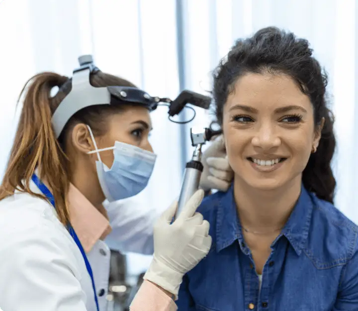 Doctor checking ear of patient