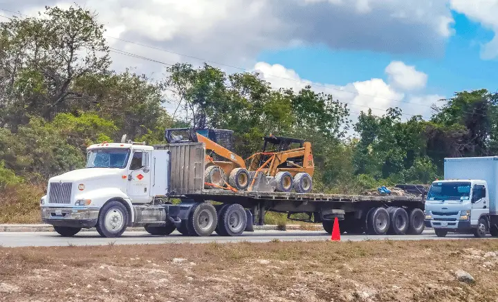 Plant equipment trailer transporting skid steer loader for plant trailer finance Australia