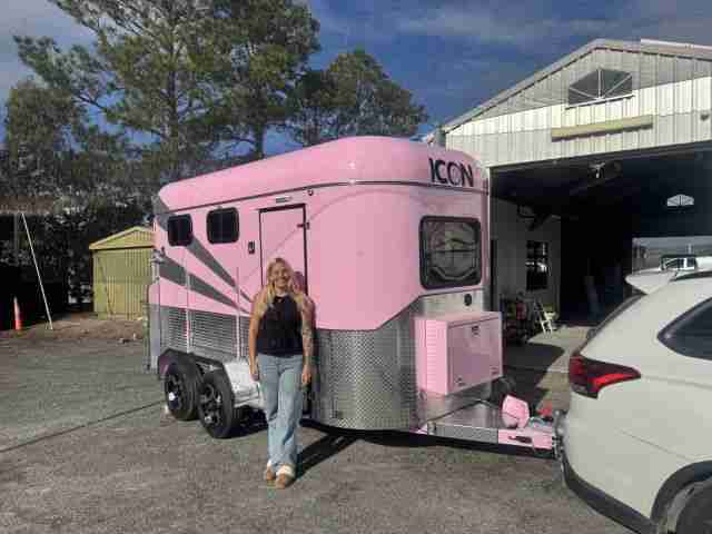 New owner standing beside a pink Icon Horse Float financed through iCREDIT.
