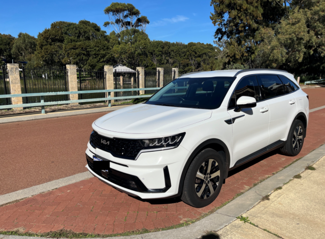 White Kia Sportage parked on a roadside in Western Australia, purchased through a private seller and financed with iCREDIT.