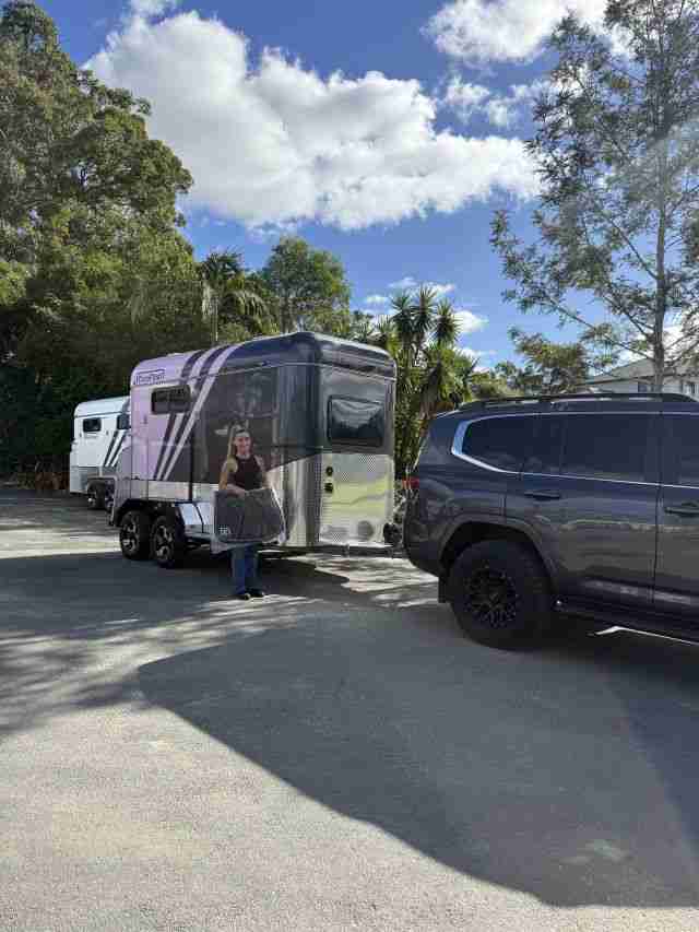 Jazmine standing beside her new Eurofloat horse float hitched to a vehicle, financed with iCREDIT Horse Float Loans.