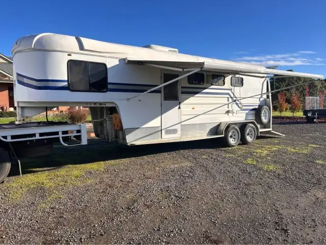 Used Tuza gooseneck horse float with living quarters and extended awning parked on a rural property in Victoria, financed through iCREDIT.
